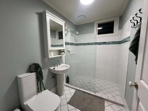 a bathroom with a toilet and a sink at Windsor Retreat City Views - Garden Suite in Brisbane