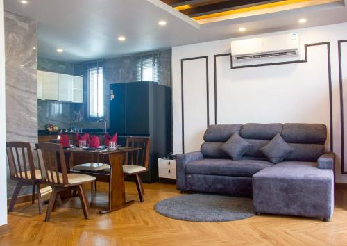 a living room with a couch and a table at Chala Number 2 Art and Gallery in Chiang Mai