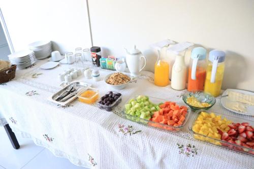 a table with fruits and vegetables in trays on it at Hotel Florez Boutique in Arequipa