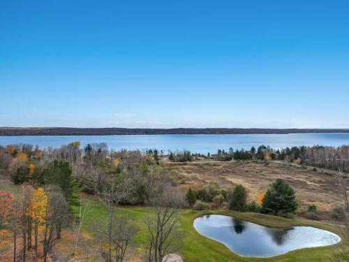 an aerial view of a golf course with a lake at Torch Lake Vista A Ga Ming Golf Retreat 741 Unit 9B in Creswell