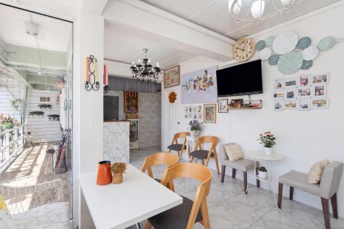 a restaurant with tables and chairs and a tv on the wall at Take a Rest Donmueang in Ban Don Muang (1)