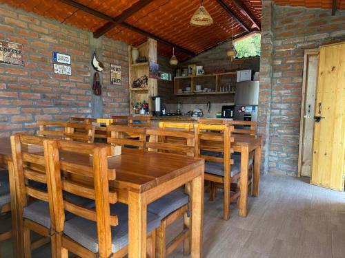a dining room with wooden tables and chairs at Sigchos Lodge in Sigchos