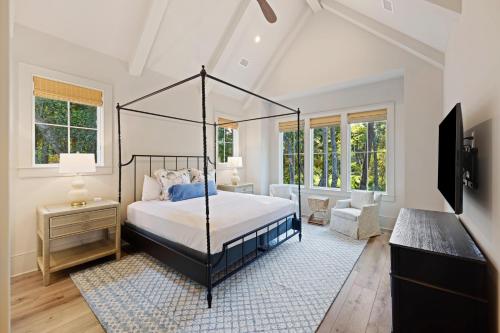 a bedroom with a canopy bed and a television at BW3131: 3131 Baywood Drive in Seabrook Island