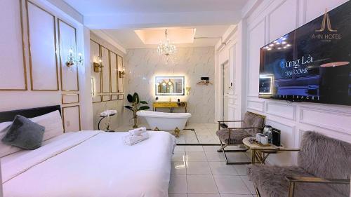 a bedroom with a bed and a bath tub and a sink at A In Hotel Glamour in Ho Chi Minh City