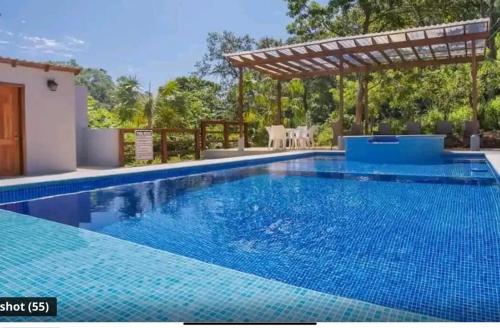 a swimming pool in a villa with a pergola at Serenity Luxury Villa in Sandy Bay