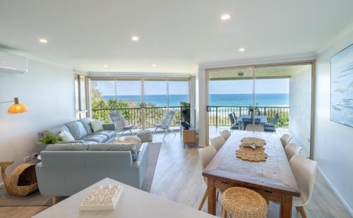 a living room with a couch and a table at Whalewatch Ocean Beach Resort in Point Lookout