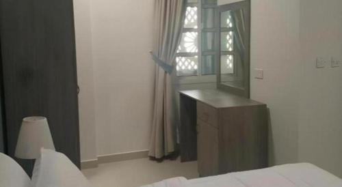 a bedroom with a bed and a mirror and a window at Sovereign Hotel - Marriage Certificate Required in Doha