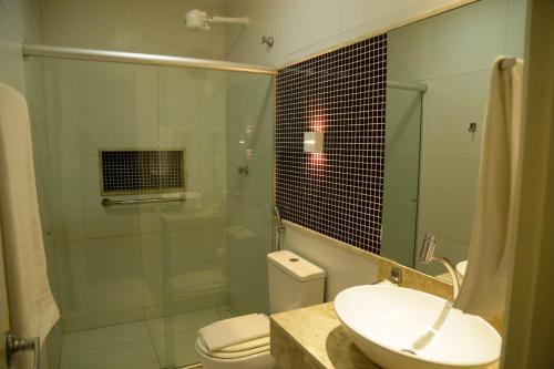 W łazience znajduje się umywalka, toaleta i prysznic. w obiekcie Caruaru Park Hotel w mieście Caruaru