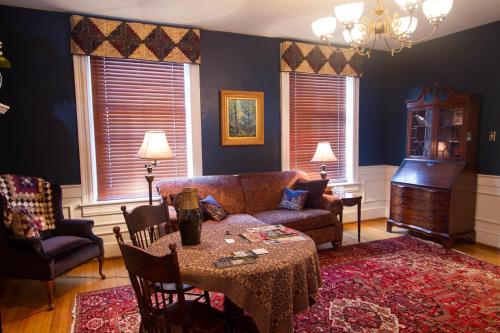 a living room with a couch and a table at The Inn at Lincoln Square in Gettysburg