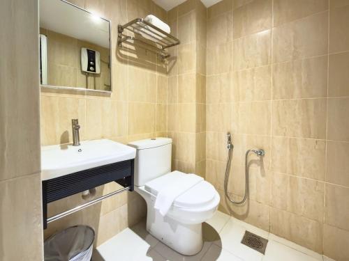 a bathroom with a toilet and a sink at Living At DSulaiman Hotel in Kuala Lumpur
