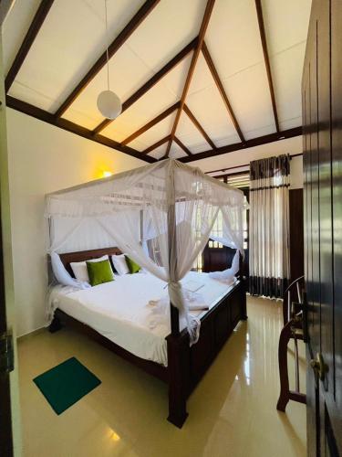 a large bed with a canopy in a room at Suzzi Villa in Weligama