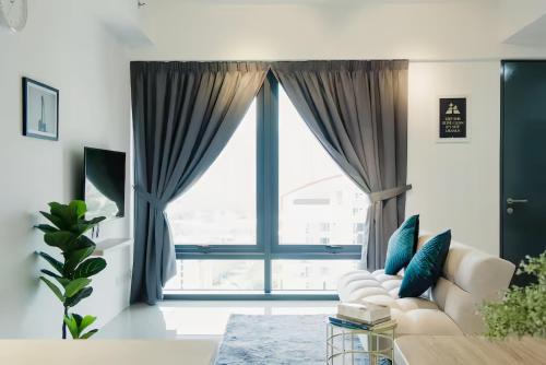 a living room with a couch and a large window at Tropicana 218 Macalister in George Town