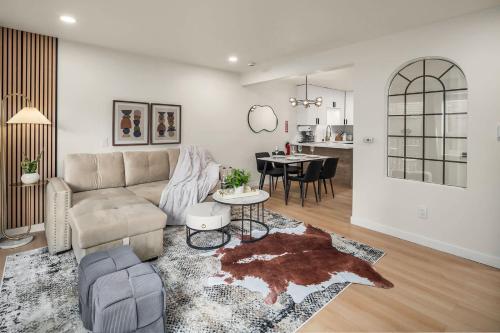 a living room with a couch and a table at Brand New 2BR Queen Anne Condo Designer's Taste in Seattle