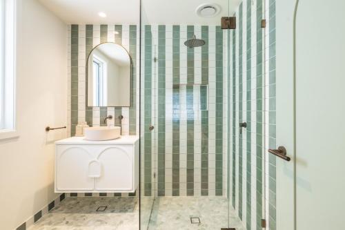 芬加尔湾Ornos, 1-14 Market St - ducted air con, cot, highchair, Linen and Bed Making的带淋浴、水槽和镜子的浴室