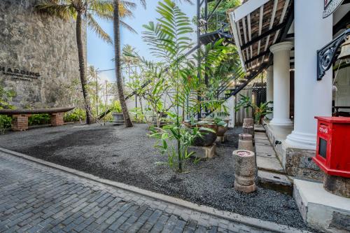 a courtyard of a house with palm trees at Secret Beach Ahangama in Ahangama