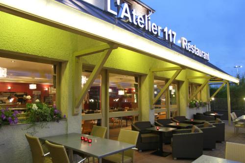 a restaurant with tables and chairs in front of it at Best Western l'Atelier 117 in Maubeuge