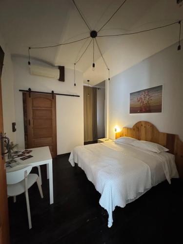 a bedroom with a bed and a table and a desk at La Locanda della Mandria 1 in Venaria Reale