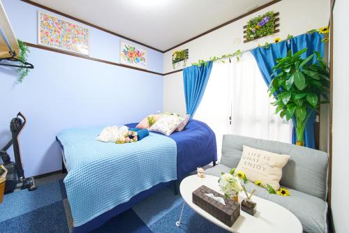 a bedroom with two beds and a couch at Belmont 202 3min to Station Easy Access Ueno Asakusa Skytree Sleeps 5 in Tokyo