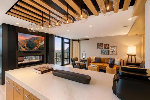 a kitchen and living room with a couch and a table at Pure Voyage Shaw in Washington, D.C.