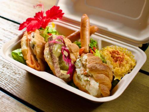 a plastic container filled with a sandwich and french fries at MORIYA iriomote HOTEL in Urauchi