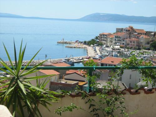 a view of a town with a harbor and the water at Adria Apartments in Podgora