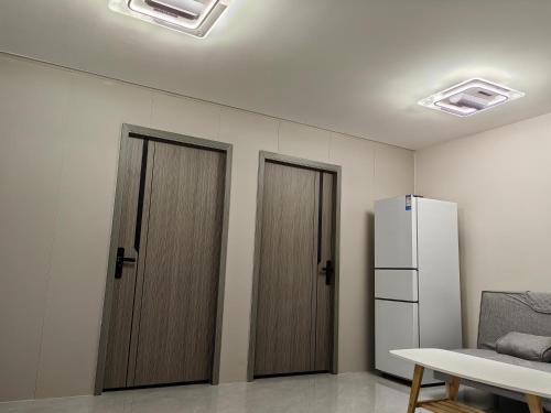 南迪Helen House一间带独立卫生间的温馨卧室的有两扇门和一台冰箱的房间