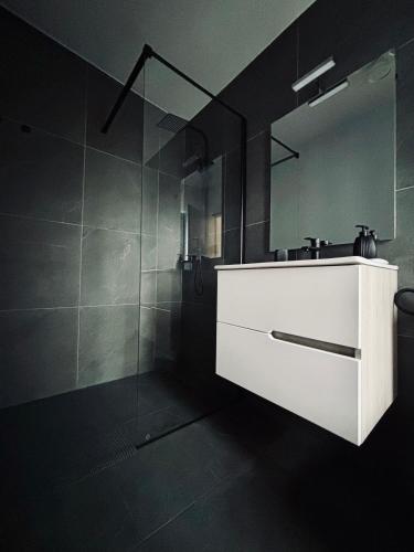 a bathroom with a white sink and a mirror at Casuta cu ciubar Valea Avrigului - Secret Forest in Avrig