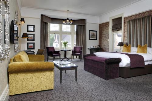a hotel room with a bed and a living room at Pontlands Park Hotel in Chelmsford