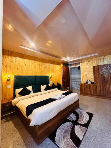 a bedroom with a large bed in a room at Shail Shikhar Heritage Inn in Joshīmath