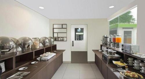 a large kitchen with a bunch of food on display at IXO Bekasi in Bulanbulan