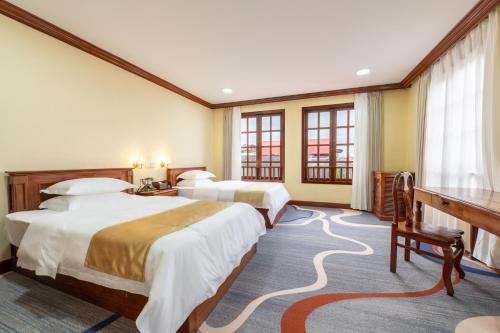 Postel nebo postele na pokoji v ubytování Domi Hotel