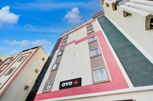 a building with an oops sign on the side of it at Hotel O PRIME HUB in Lingampalli