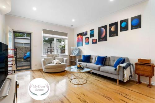 a living room with a couch and a table at Lego-Aerospace Free Parking CBD Chinatown in Adelaide