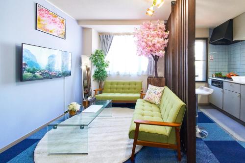a living room with a couch and a glass table at AO201 - Tokyo Stay Spacious Apartment Direct Train to Narita & Asakusa in Tokyo
