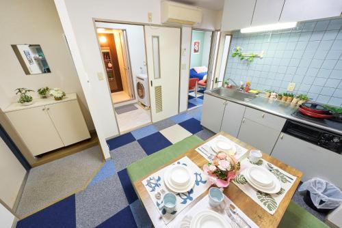 a small kitchen with a table and plates on it at AO101 - Tokyo Stay Spacious Apartment Direct Train to Narita & Asakusa in Tokyo
