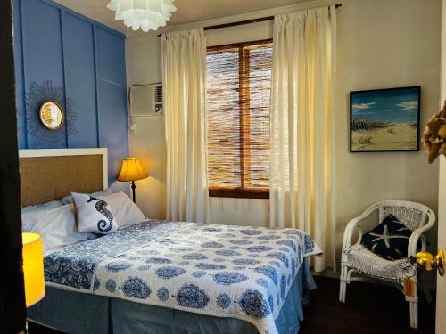 a bedroom with a bed and a window at Anton & Isabel Charming Home in Bangued in Bangued