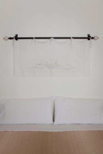 a white table in a room with a window at Hotel Santa Marina Antica Foresteria in Santa Marina Salina