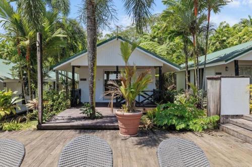 a house with two chairs on a wooden deck at Orator Hotel in Siusega