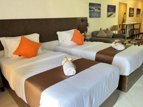 宿务88th Avenue的酒店房间里的三张床上有毛巾