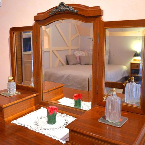 a bedroom with a large mirror and a bed at Le Café du Village - Bar à cocktails & à Ambiance in Lohéac