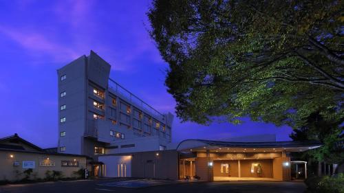 a hospital building at night with a purple sky at Hotel Symphony Annex Sagae Onsen in Sagae