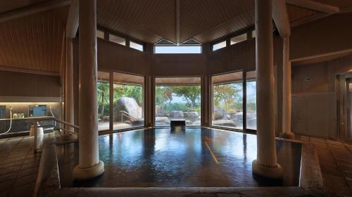 a large room with columns and a large window at Hotel Symphony Annex Sagae Onsen in Sagae