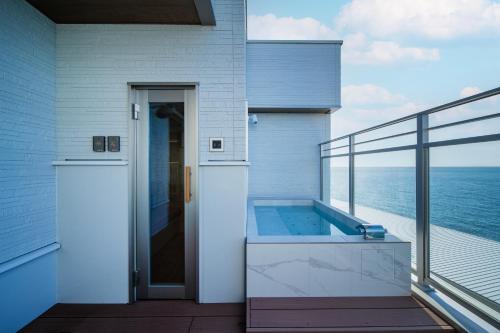 a house with a plunge pool on a balcony at THE ZK West Coast in Awaji