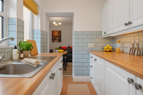 a kitchen with a sink and a counter top at Workington Haven - 3 Bed Home in Workington