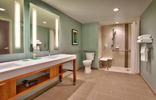 a bathroom with a sink and a toilet and a mirror at Hyatt Place Salt Lake City Farmington Station Park in Farmington