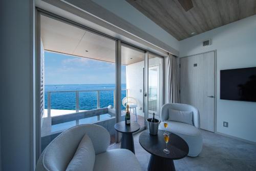 a living room with a view of the ocean at THE ZK West Coast in Awaji