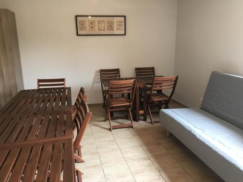 a room with wooden tables and chairs and a couch at Chalets under Falcon Ridge in Česká Ves
