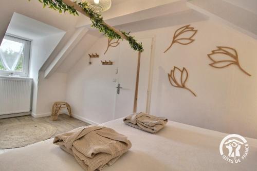 - une chambre avec un lit et une croix sur le mur dans l'établissement Le monjoie, à Langueux