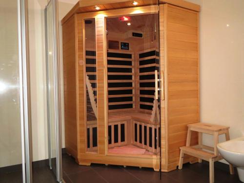 a wooden wine cellar in a bathroom with a toilet at Appartements Nassfeld LUX in Sonnenalpe Nassfeld