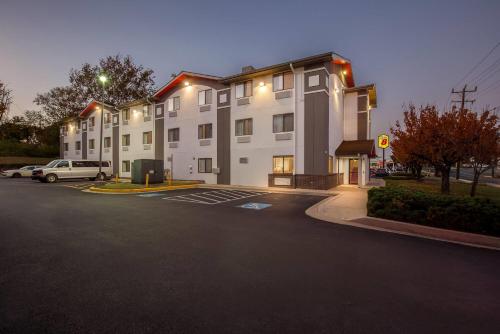 a building with a parking lot in front of it at Super 8 by Wyndham College Park Wash DC Area in College Park